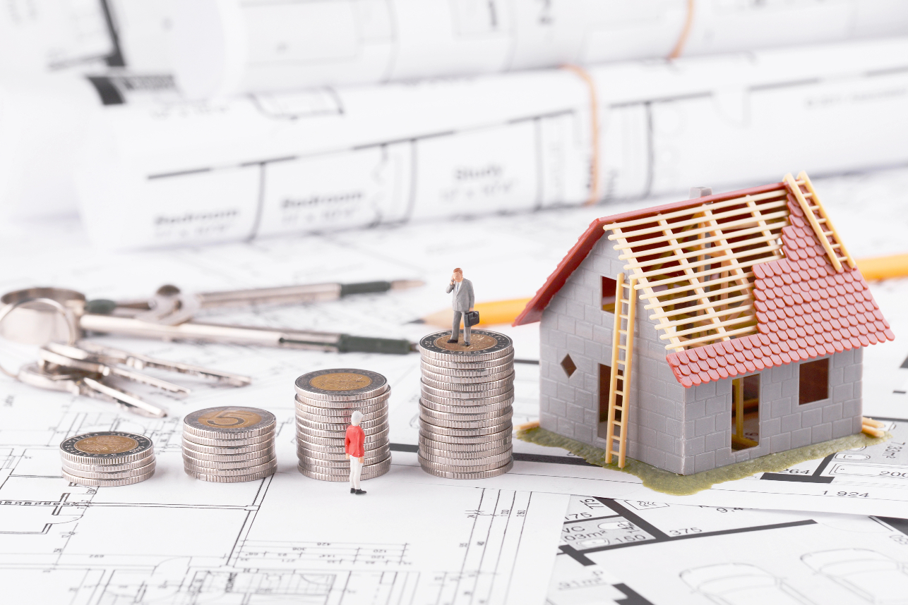 Businessman Standing On Coins